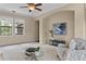Bright living room featuring tan walls, arched doorway, and a ceiling fan for a cozy atmosphere at 601 Bosphorous Ave, Tampa, FL 33606
