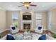 Cozy living room features a fireplace, hardwood floors, stylish seating, and a decorative ceiling fan at 601 Bosphorous Ave, Tampa, FL 33606