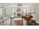 Cozy living room with a fireplace, piano, and french doors offering ample natural light at 601 Bosphorous Ave, Tampa, FL 33606
