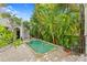 Secluded pool surrounded by lush tropical foliage, offering a private and tranquil oasis at 601 Bosphorous Ave, Tampa, FL 33606
