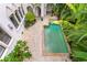 Aerial view of the rectangular pool surrounded by brick pavers and lush, tropical landscaping at 601 Bosphorous Ave, Tampa, FL 33606
