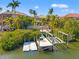 Backyard view of the pool area with boat dock and lift at 6315 Marbella Blvd, Apollo Beach, FL 33572