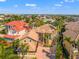 Expansive aerial view of a home with a tile roof, lush landscaping, and neighborhood at 6315 Marbella Blvd, Apollo Beach, FL 33572