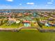 An aerial view showcasing waterfront homes, a community tennis court, and a playground at 6315 Marbella Blvd, Apollo Beach, FL 33572