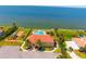 An aerial view showcasing a community recreation center with a pool, playground, and waterfront access at 6315 Marbella Blvd, Apollo Beach, FL 33572