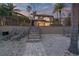 A serene backyard view with a stairway and lounge chairs, perfect for relaxation and enjoying the outdoor space at 6315 Marbella Blvd, Apollo Beach, FL 33572
