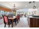 Open-concept dining area connecting to the living room, featuring a chandelier and natural lighting at 6315 Marbella Blvd, Apollo Beach, FL 33572
