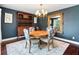 A dining room with dark blue walls, a round table, chairs, and hutch at 6315 Marbella Blvd, Apollo Beach, FL 33572