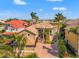 Stunning home featuring a tile roof, two-car garage, paver driveway and lush, tropical landscaping at 6315 Marbella Blvd, Apollo Beach, FL 33572