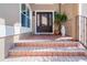Inviting home entrance featuring a solid door, elegant brick steps, and manicured plants at 6315 Marbella Blvd, Apollo Beach, FL 33572