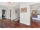 Spacious hallway with dark wood floors and access to multiple rooms, including a view of the bedroom at 6315 Marbella Blvd, Apollo Beach, FL 33572