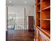 Open hallway features hardwood floors, iron railing, and an upper level view to the pool area at 6315 Marbella Blvd, Apollo Beach, FL 33572