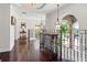Hallway features hardwood floors, decorative railing, and architectural details with chandelier lighting at 6315 Marbella Blvd, Apollo Beach, FL 33572