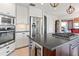 Modern kitchen with stainless steel appliances, a cooktop island, and bright lighting at 6315 Marbella Blvd, Apollo Beach, FL 33572