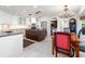 Modern kitchen featuring white cabinetry, a dark wood island, and an adjacent dining area with a chandelier at 6315 Marbella Blvd, Apollo Beach, FL 33572