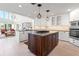 Bright, updated kitchen featuring an island cooktop, white cabinets, and contemporary lighting at 6315 Marbella Blvd, Apollo Beach, FL 33572