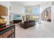 Spacious living room featuring high ceilings, large windows, and a decorative chandelier at 6315 Marbella Blvd, Apollo Beach, FL 33572