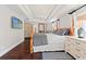 Spacious main bedroom featuring a comfortable bed and dresser, a tv, and a large ceiling light fixture at 6315 Marbella Blvd, Apollo Beach, FL 33572