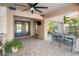 Inviting covered patio featuring brick pavers, a ceiling fan, and a comfortable seating area at 6315 Marbella Blvd, Apollo Beach, FL 33572