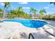 Inviting backyard pool surrounded by a spacious paved deck and lush tropical landscaping for relaxation and entertainment at 6315 Marbella Blvd, Apollo Beach, FL 33572