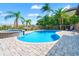 Enjoy a luxurious pool and spa area, enhanced by lush palm trees and blue skies on a sunny day at 6315 Marbella Blvd, Apollo Beach, FL 33572