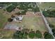 Expansive property boasts a ranch-style house, horse stables, and a sizable lot outlined in red at 6709 W Knights Griffin Rd, Plant City, FL 33565