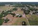 Aerial view featuring ranch-style home, enclosed pool, horse stables, and large lot outlined in red at 6709 W Knights Griffin Rd, Plant City, FL 33565