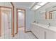 Modern bathroom with double sinks, white cabinets, and a well-lit vanity area at 6709 W Knights Griffin Rd, Plant City, FL 33565