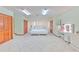 Spacious bedroom featuring tile flooring, ample closet space, and a ceiling fan for climate control at 6709 W Knights Griffin Rd, Plant City, FL 33565