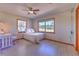 Bedroom featuring two windows, wood trim, and a view of an open field at 6709 W Knights Griffin Rd, Plant City, FL 33565