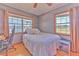 Bedroom featuring two windows, a ceiling fan, and neutral colored walls at 6709 W Knights Griffin Rd, Plant City, FL 33565