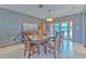 Elegant dining room with modern lighting and views of the backyard provides a great space to entertain at 6709 W Knights Griffin Rd, Plant City, FL 33565