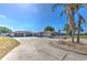 Sprawling ranch home boasts a circular driveway, neutral paint, and a spacious three-car garage at 6709 W Knights Griffin Rd, Plant City, FL 33565