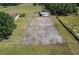 Horse corral with a large paddock and metal fence under a blue sky, with a barn nearby at 6709 W Knights Griffin Rd, Plant City, FL 33565