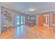 Inviting living area with stylish decor, wood flooring, and access to outdoor pool at 6709 W Knights Griffin Rd, Plant City, FL 33565