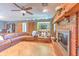 Open living space featuring a large leather sofa, fireplace, and access to the outdoors at 6709 W Knights Griffin Rd, Plant City, FL 33565