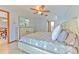 Bright bedroom with ample natural light, ceiling fan, and en-suite bathroom at 6709 W Knights Griffin Rd, Plant City, FL 33565