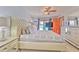 Brightly lit main bedroom featuring a ceiling fan, patio access and a vanity at 6709 W Knights Griffin Rd, Plant City, FL 33565