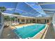 Enclosed in-ground pool provides a serene and private backyard oasis with ample space for lounging at 6709 W Knights Griffin Rd, Plant City, FL 33565