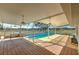 Screened-in pool area features an outdoor bar, ceiling fans, and views of the surrounding horse pastures at 6709 W Knights Griffin Rd, Plant City, FL 33565