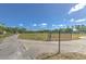 Gated entrance leads to open land; ideal for development or enjoying nature and privacy at 6709 W Knights Griffin Rd, Plant City, FL 33565