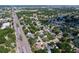 Aerial shot captures the neighborhood's mature trees, access to the major roadways, pond, and nearby commercial areas at 7307 Summerbridge Dr, Tampa, FL 33634