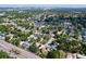 Aerial view showcasing the neighborhood's pond, lush trees, proximity to a roadway, and residential homes with pools at 7307 Summerbridge Dr, Tampa, FL 33634