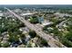 An aerial view showcases a suburban neighborhood with lush trees and easy access to nearby roadways and a large pond at 7307 Summerbridge Dr, Tampa, FL 33634