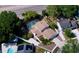 High angle aerial view of home and neighborhood featuring screened in pool, landscaping, and driveway at 7307 Summerbridge Dr, Tampa, FL 33634