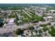 An aerial view highlights the neighborhood's mature trees, nearby pond, access to major roads, and varied housing styles at 7307 Summerbridge Dr, Tampa, FL 33634