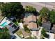Aerial view showcases home featuring fenced yard, screened-in pool, landscaping and circular driveway at 7307 Summerbridge Dr, Tampa, FL 33634
