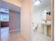 Clean bathroom with tile flooring, pedestal sink, and toilet at 7307 Summerbridge Dr, Tampa, FL 33634