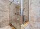 Modern tiled shower featuring a glass door, grab bars, and shower seat at 7307 Summerbridge Dr, Tampa, FL 33634