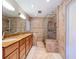 Elegant bathroom with double sinks, granite counters, and a glass-enclosed shower at 7307 Summerbridge Dr, Tampa, FL 33634